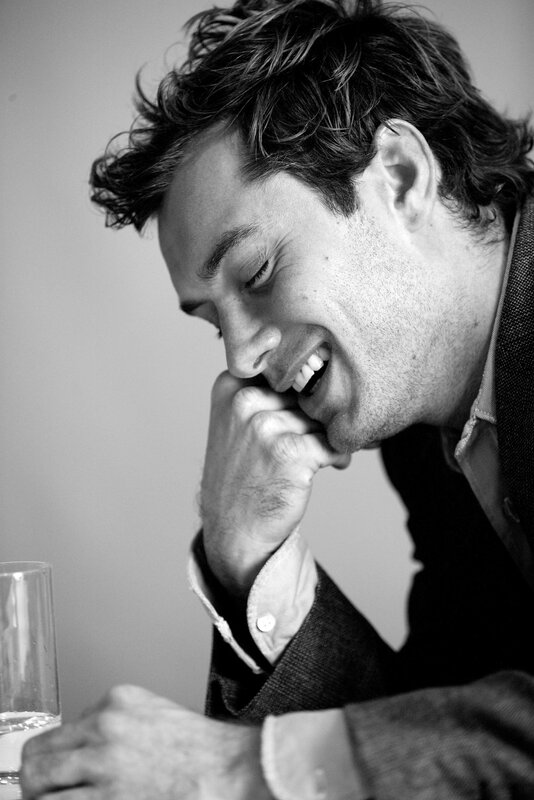 man laughing at table