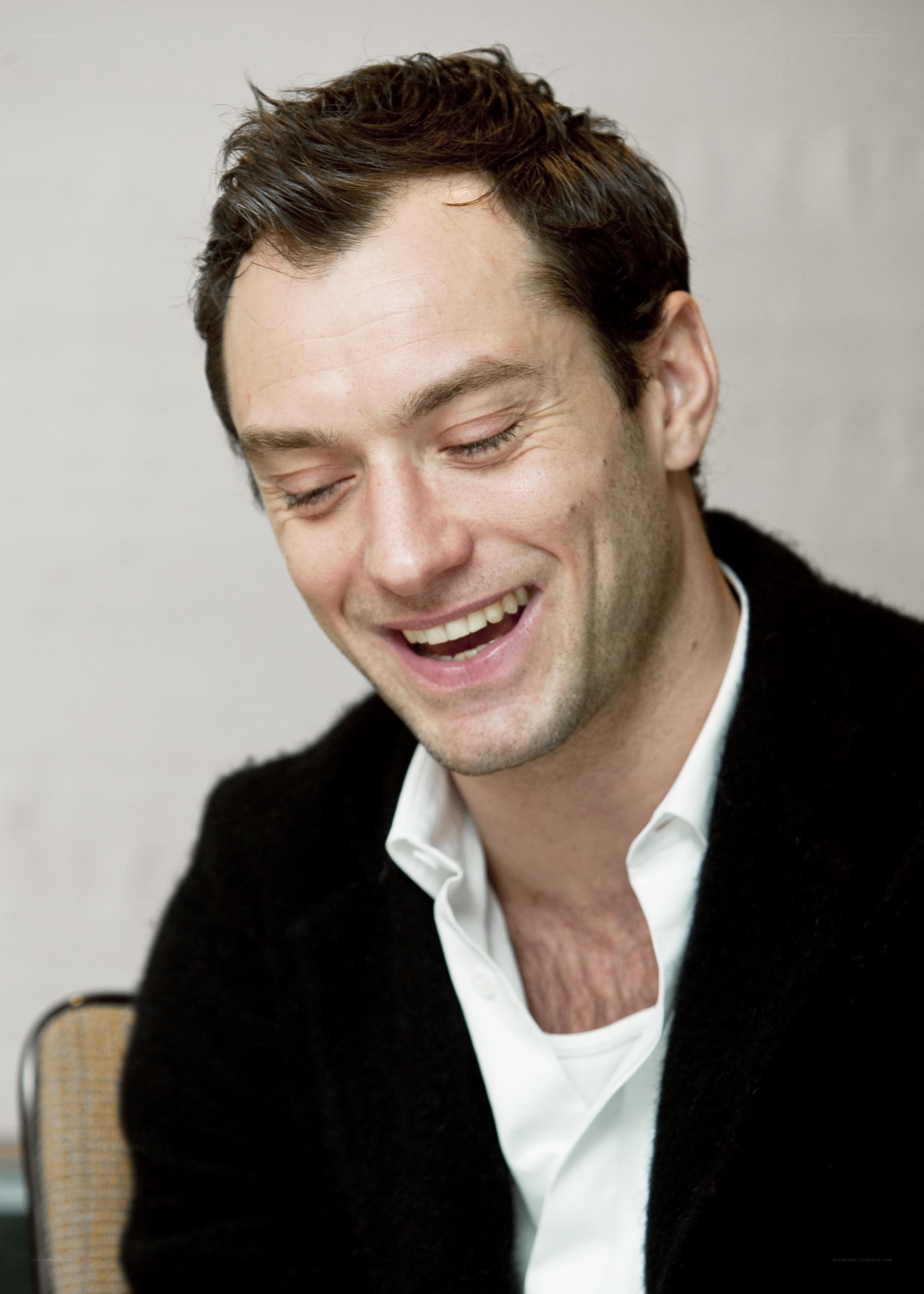 man laughing in black jacket