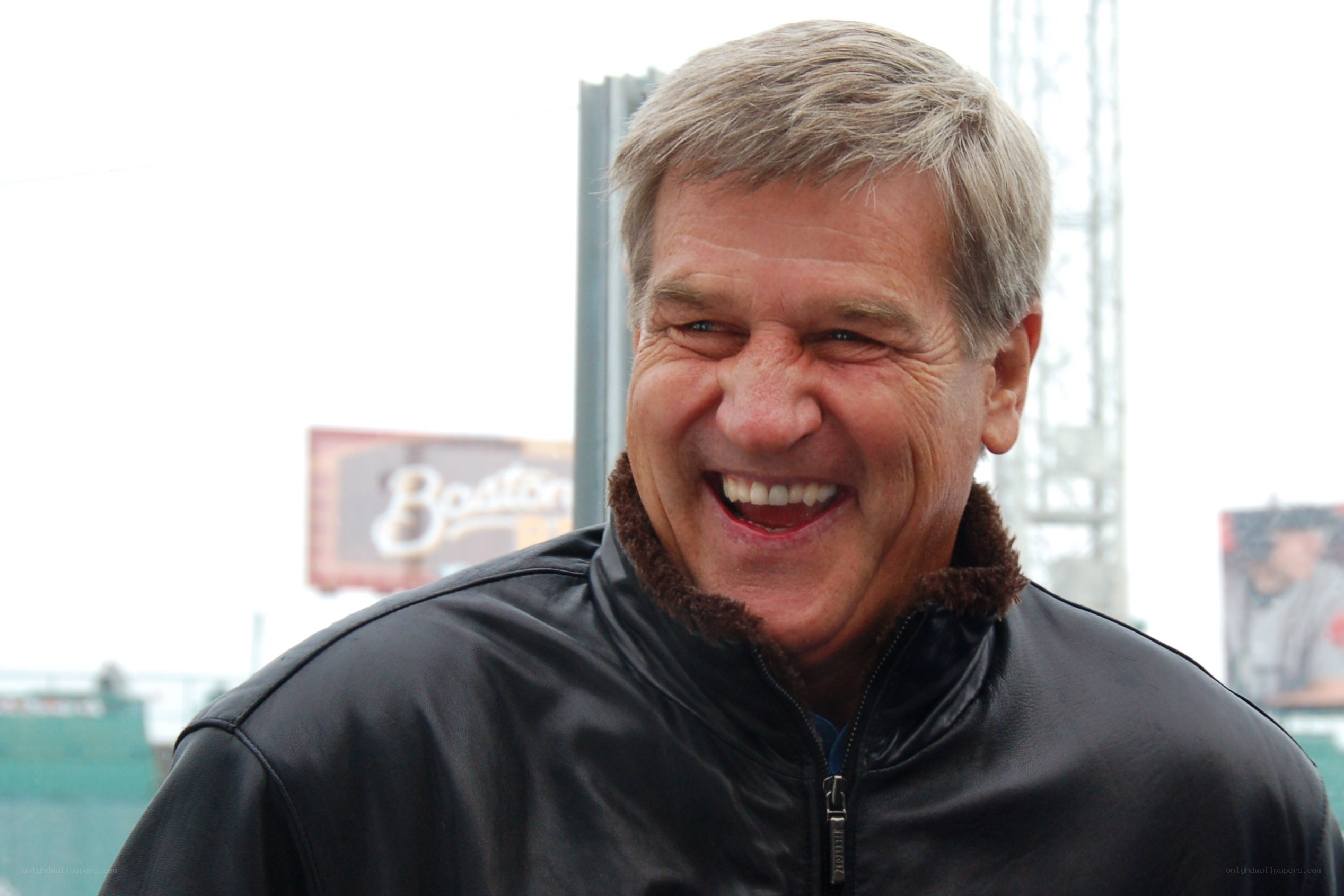 man laughing in leather jacket
