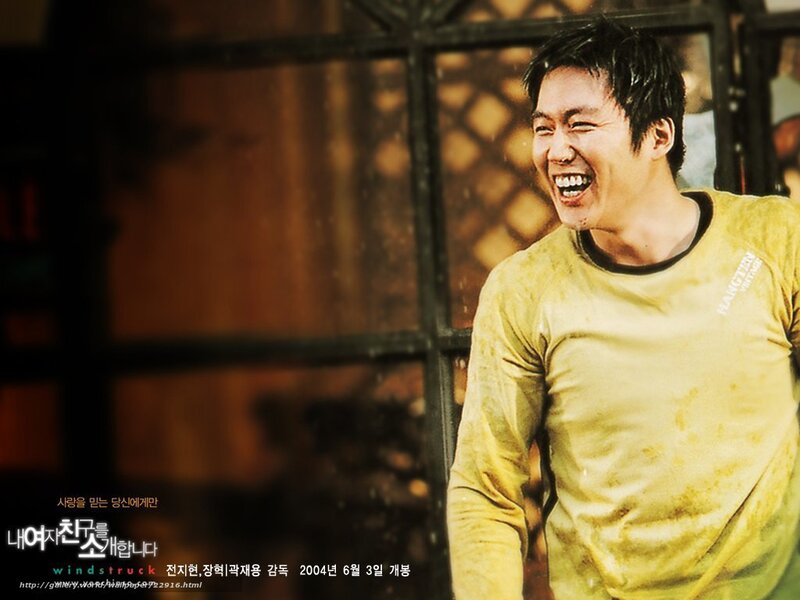 man laughing in yellow shirt