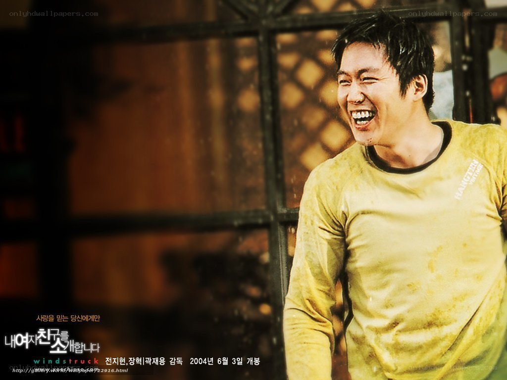 man laughing in yellow shirt