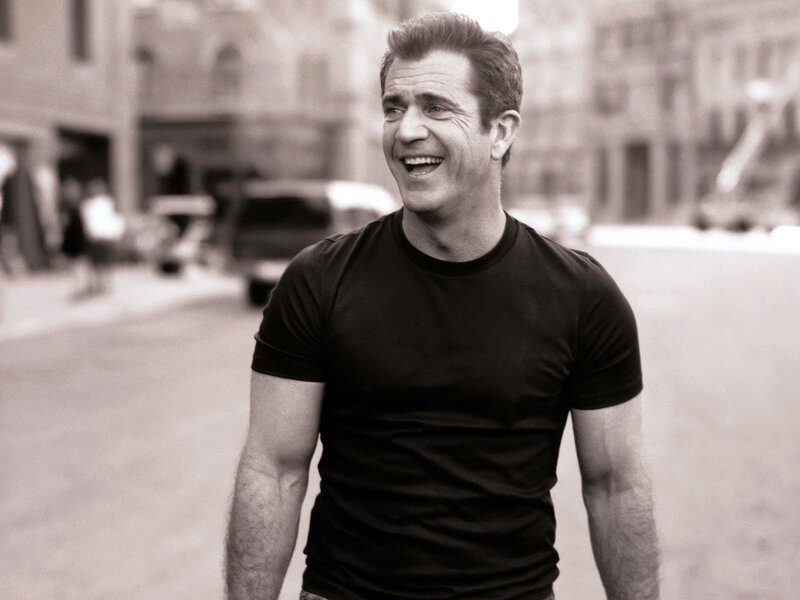 man laughing on city street