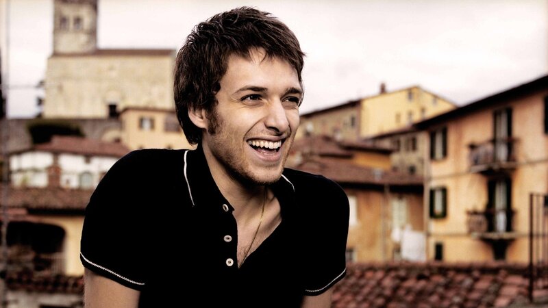 man laughing on rooftop