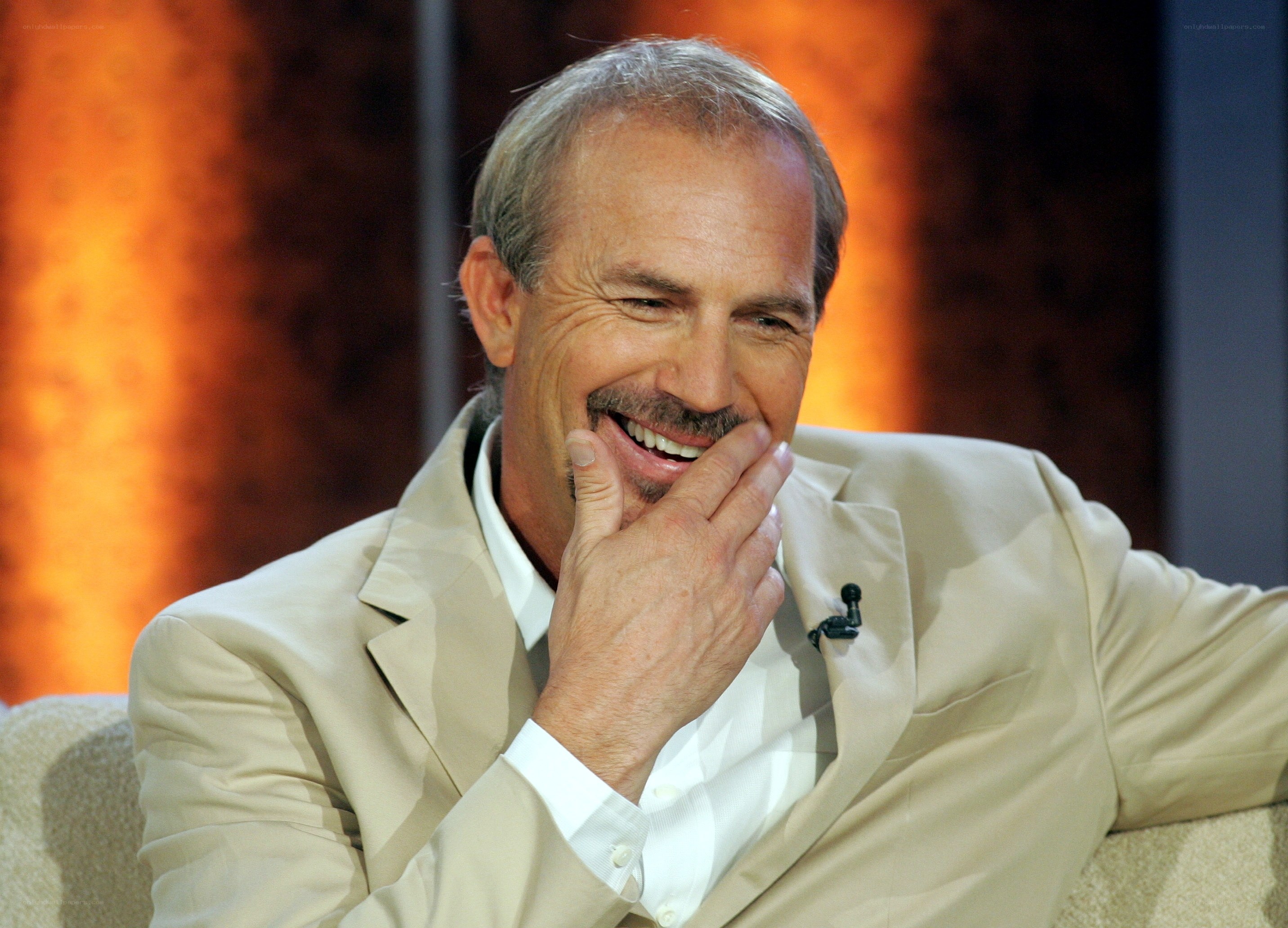man laughing on talk show