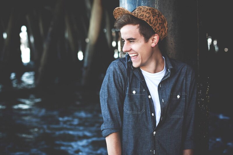 man laughing under pier