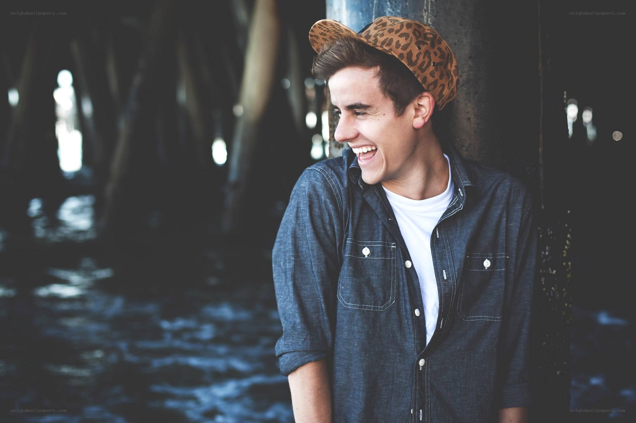 man laughing under pier