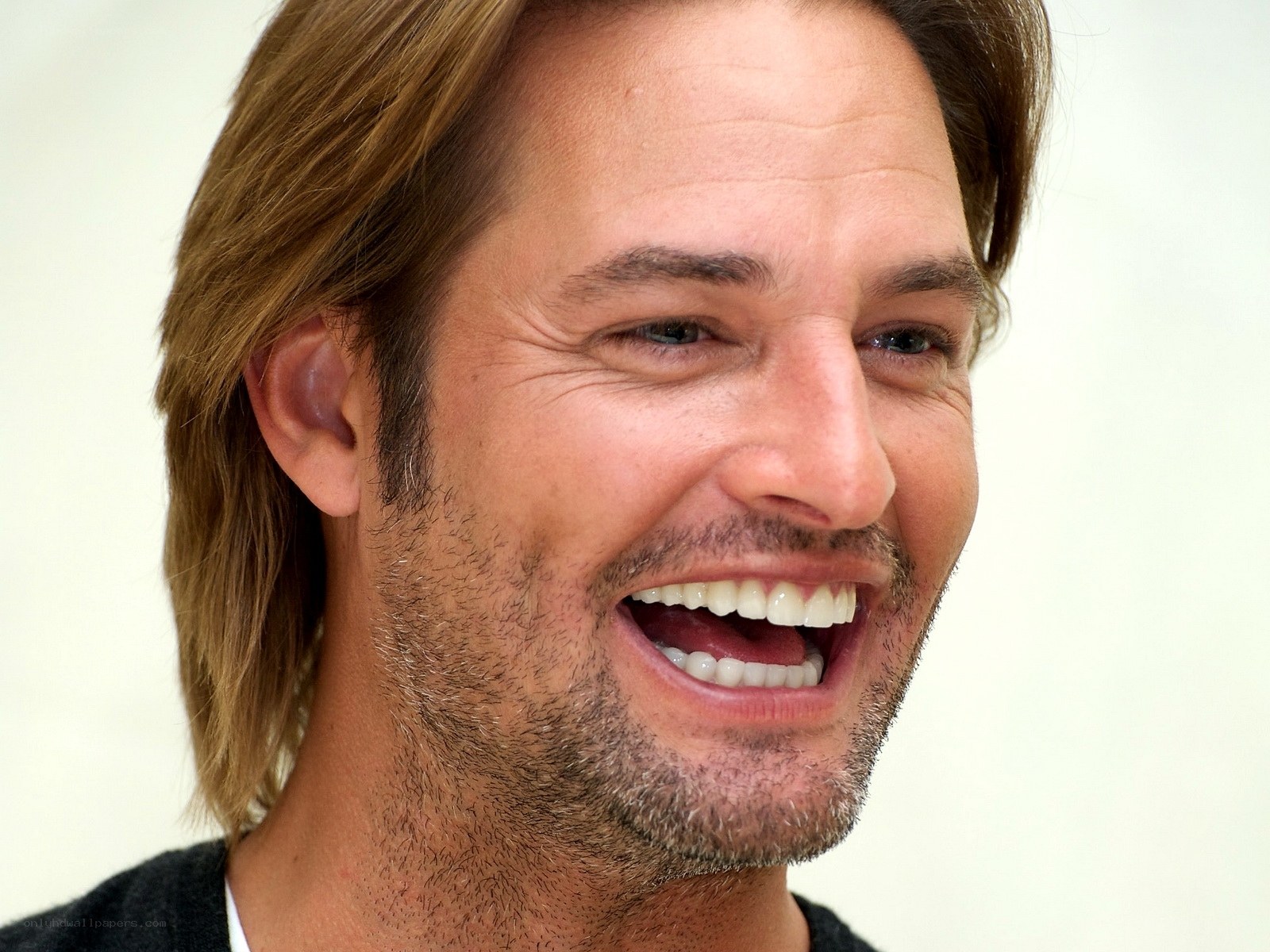 man laughing with long hair