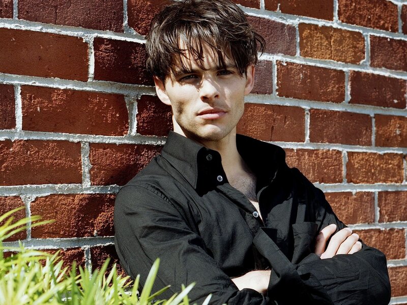 Man Leaning Against Brick Wall — Black