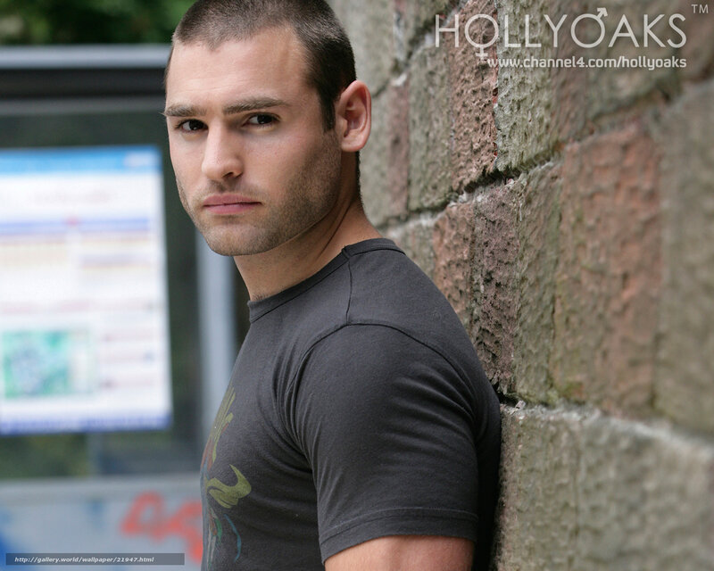 man leaning against brick wall