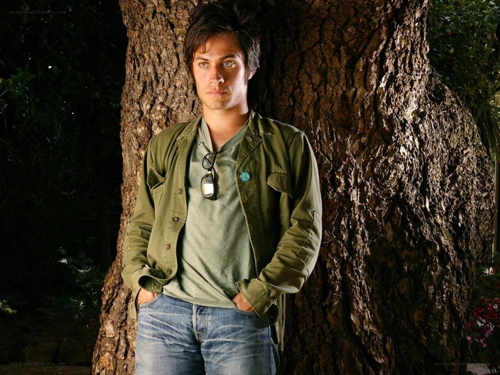 man leaning against tree