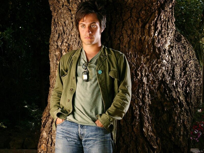 Man Leaning Against Tree — Green, Serious