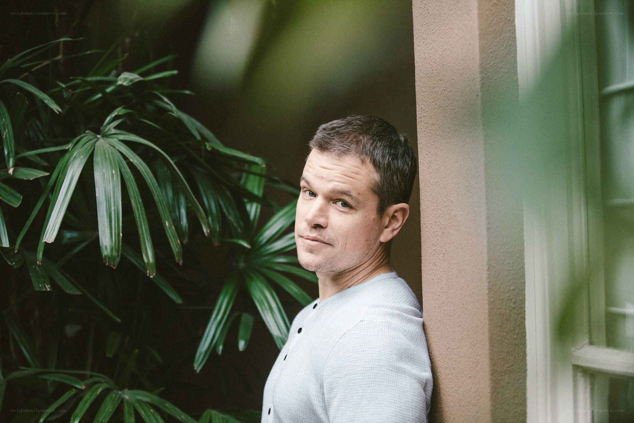 man leaning against wall