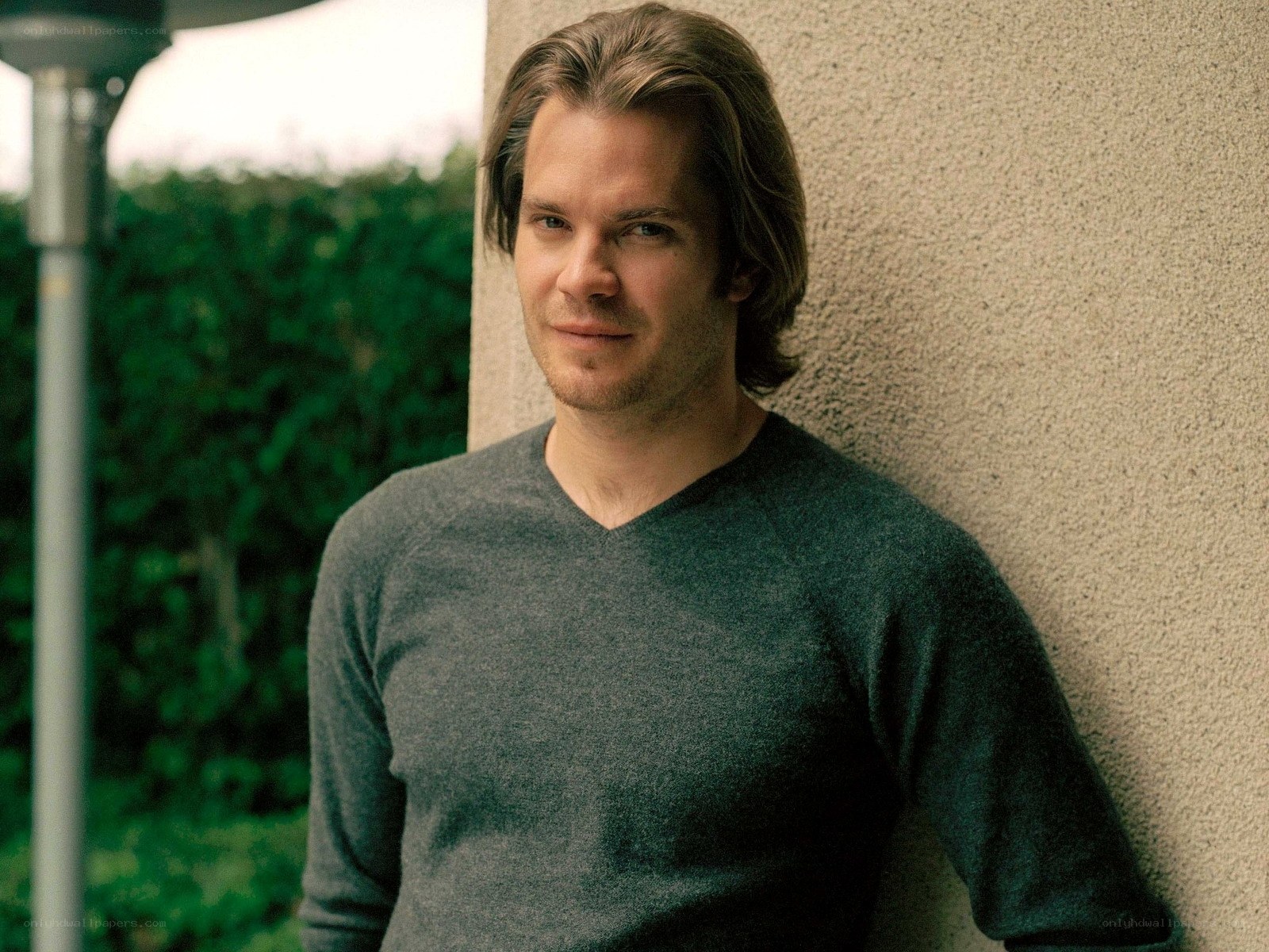 man leaning against wall