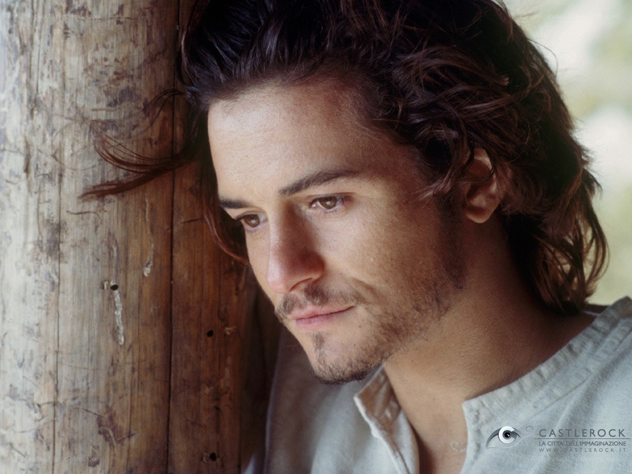 man leaning against wooden wall