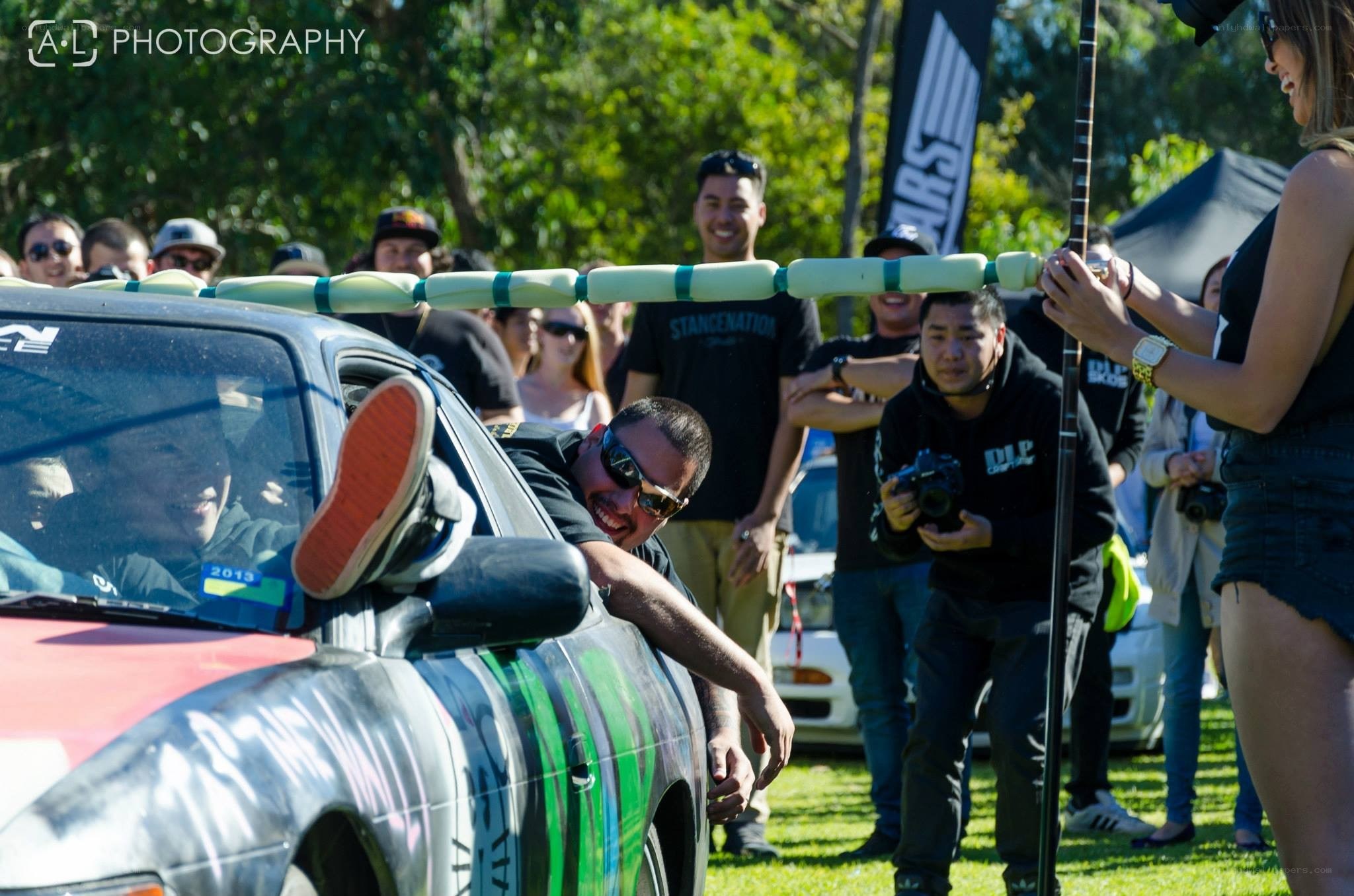 Man leaning from car at outdoor event