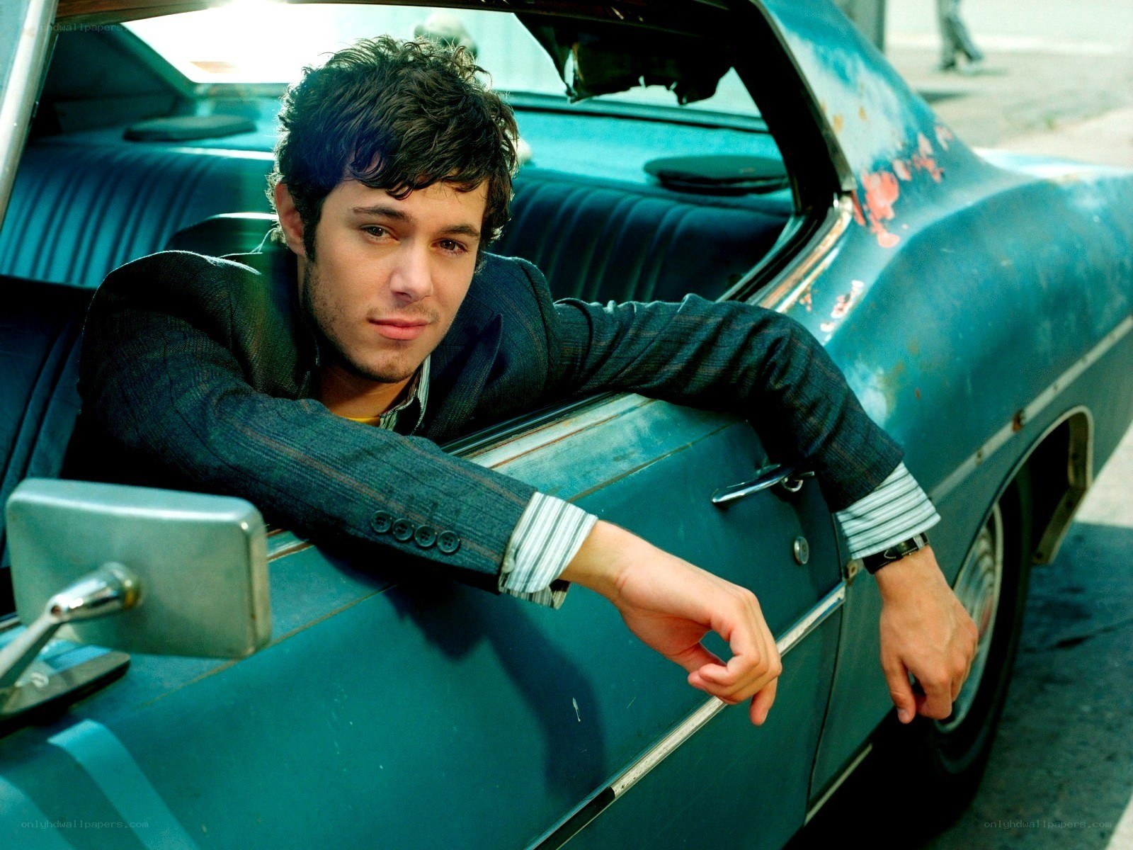 man leaning from car window