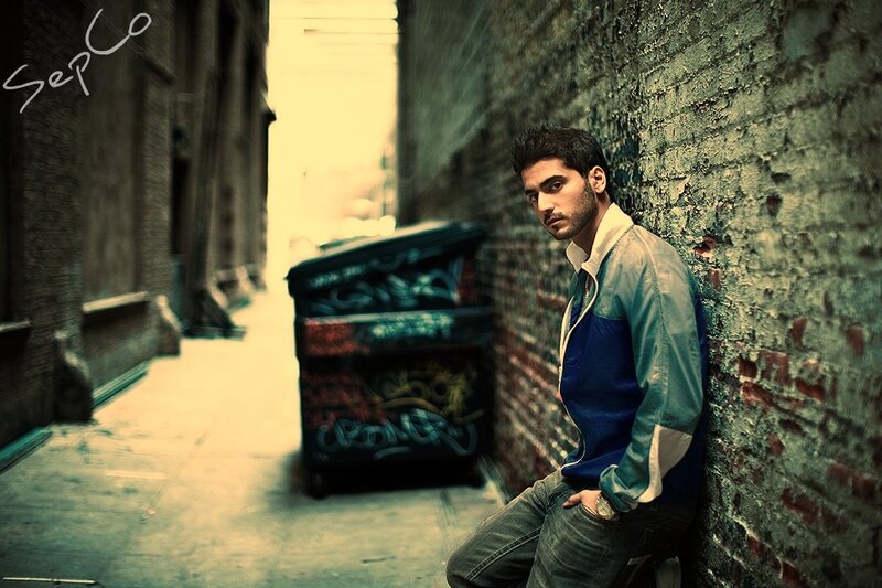 man leaning in alleyway