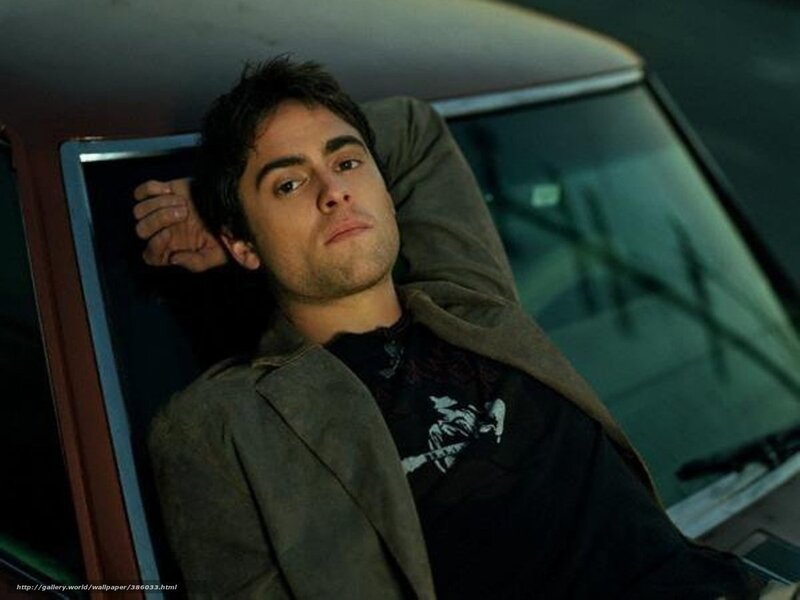 man leaning in car window