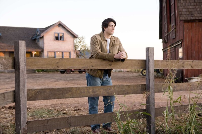 Man leaning on a fence