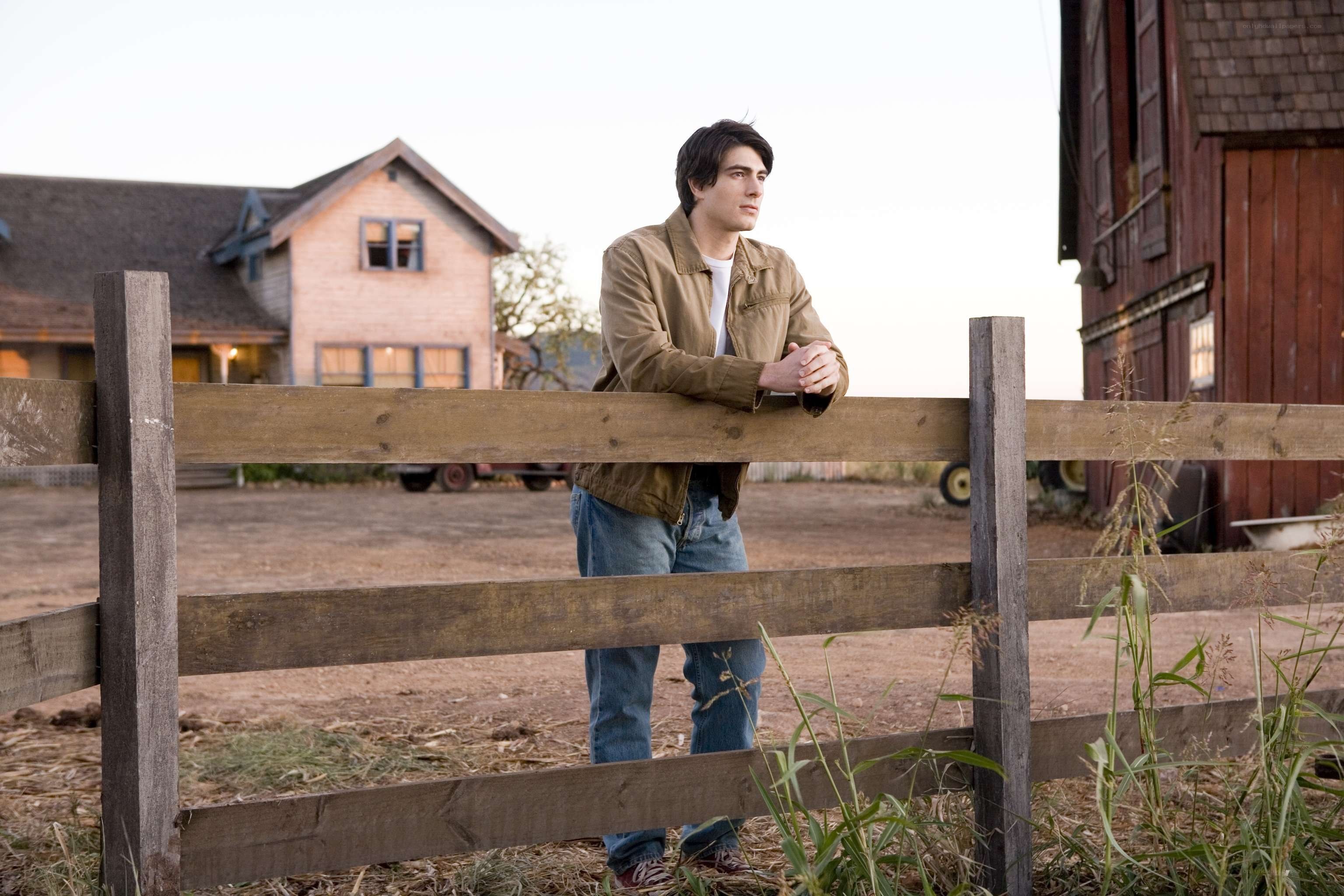 Man leaning on a fence