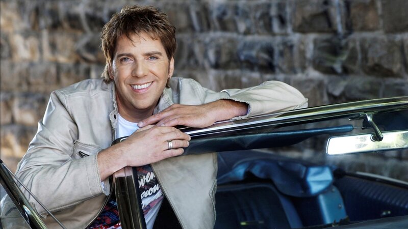 man leaning on car