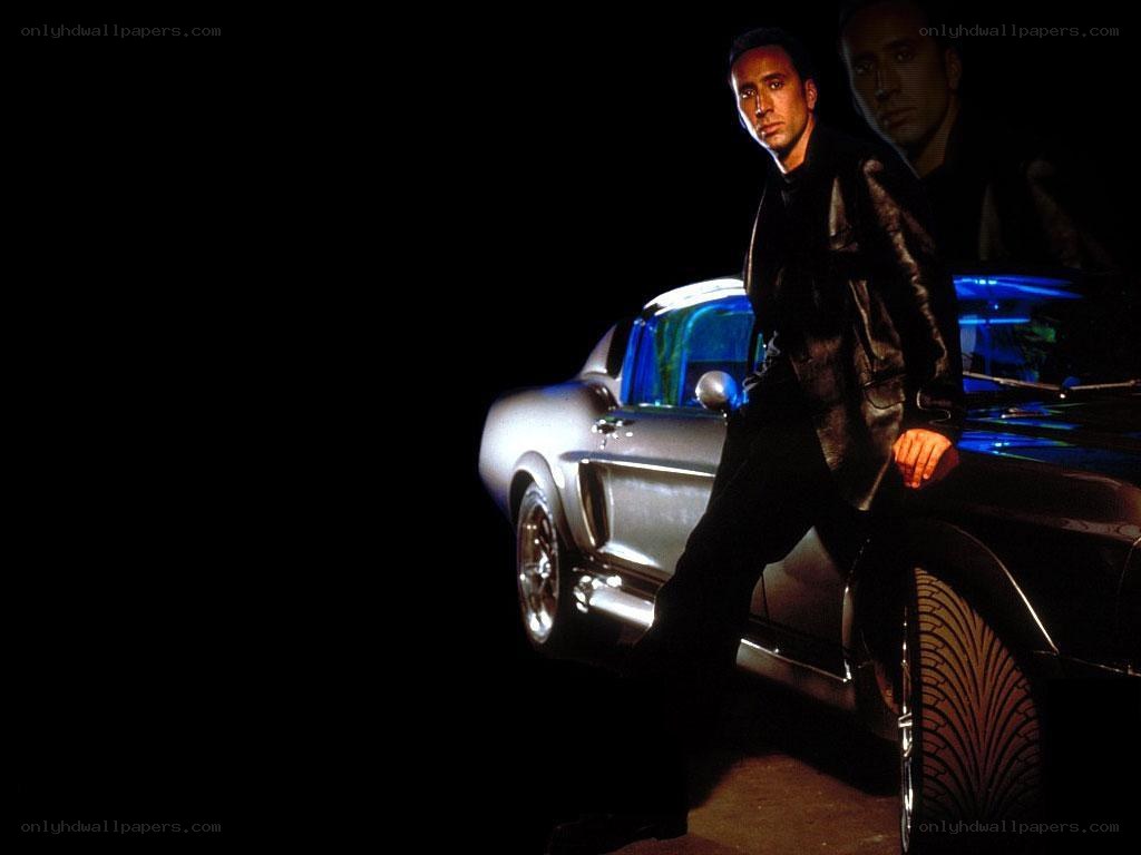 man leaning on classic car