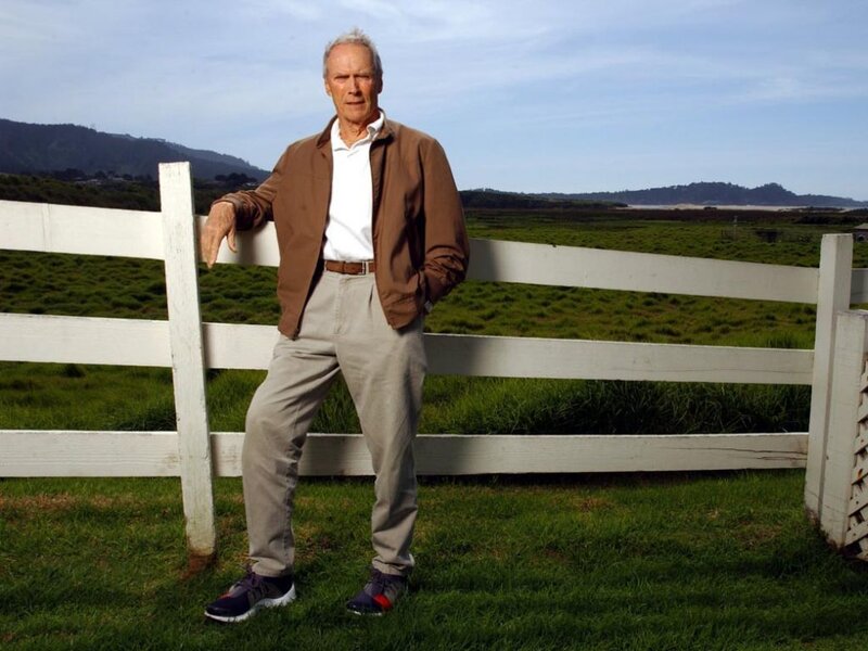 Man Leaning on Fence