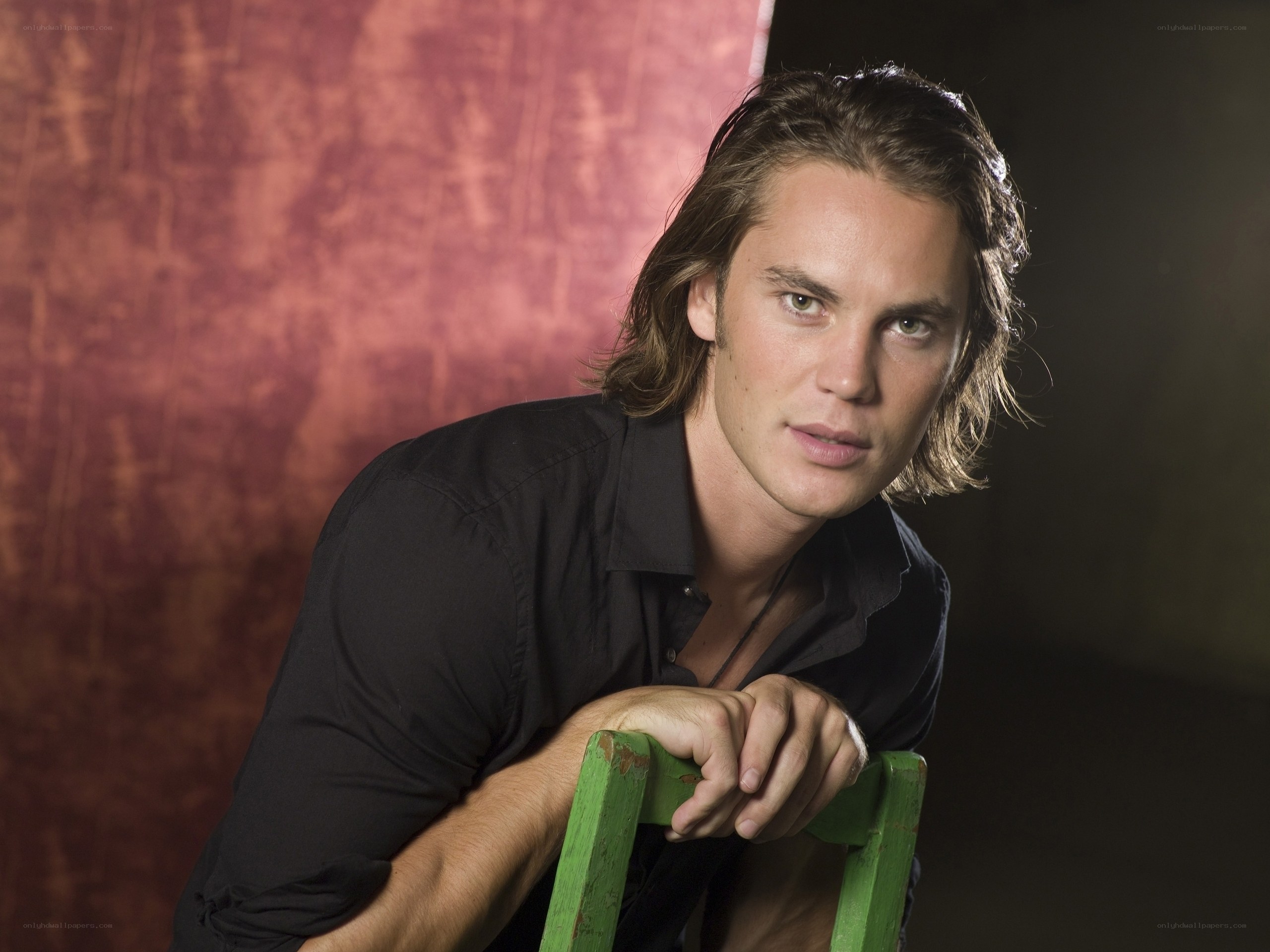 man leaning on green chair