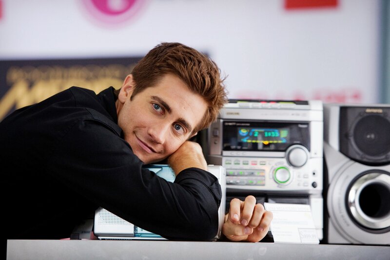 man leaning on stereo system