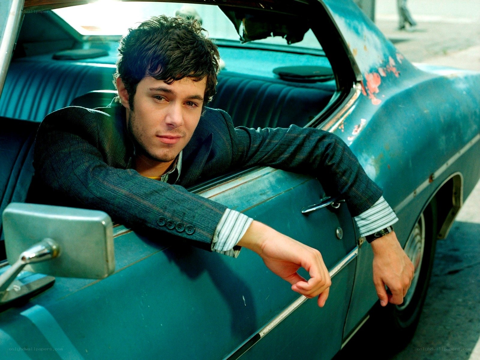 man leaning on vintage car