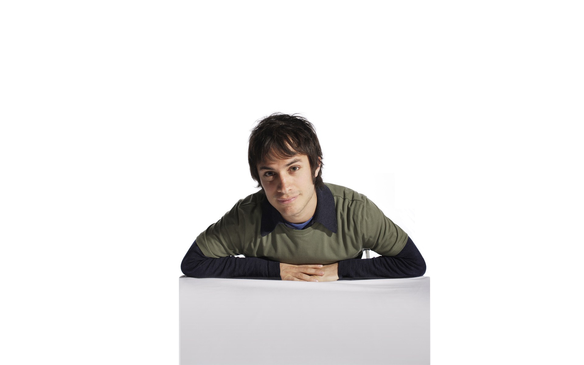 man leaning on white box
