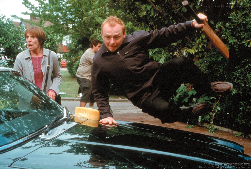 Man leaping over car with sword