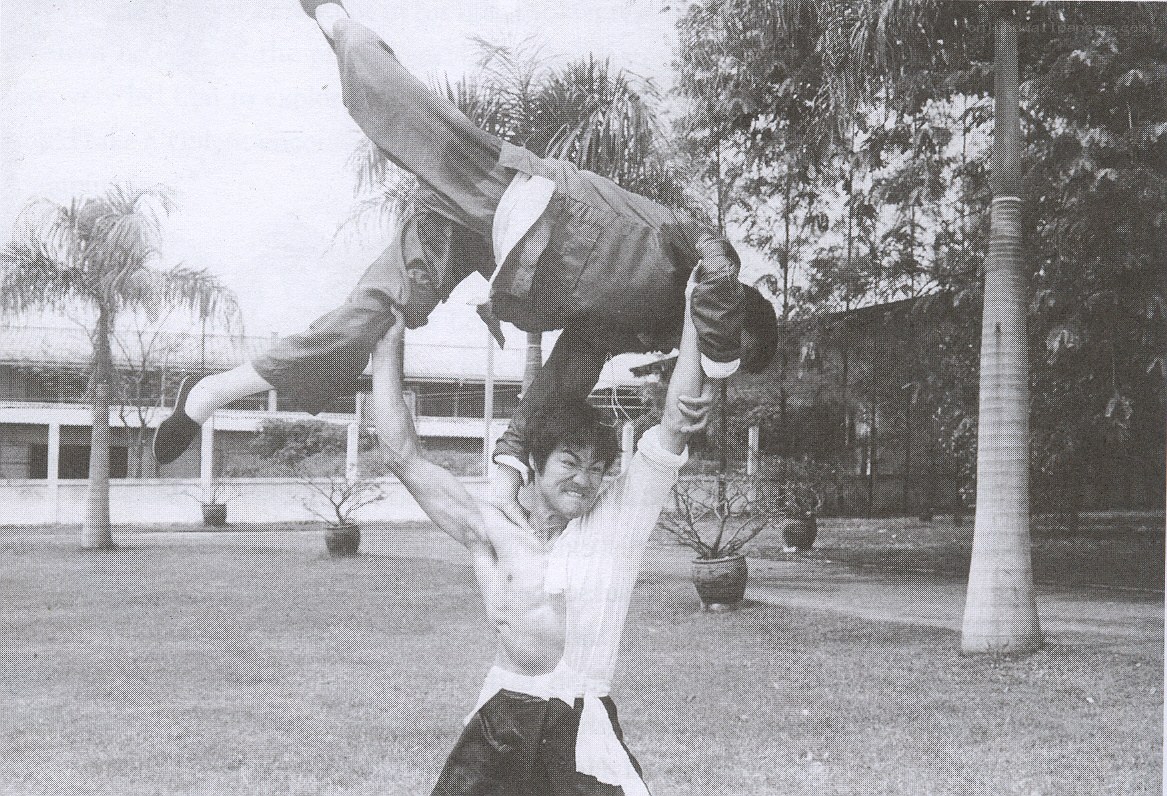Man lifting another in martial arts pose