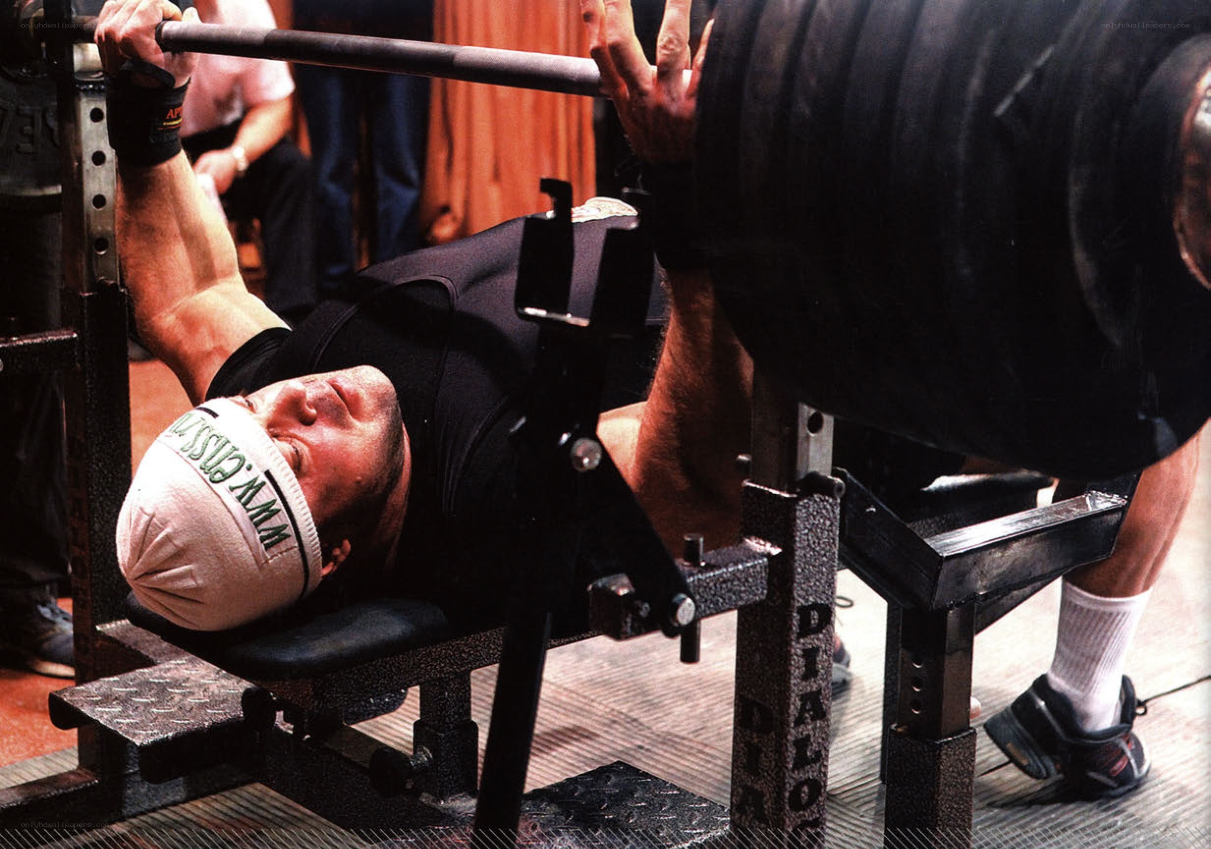 man lifting barbell on bench