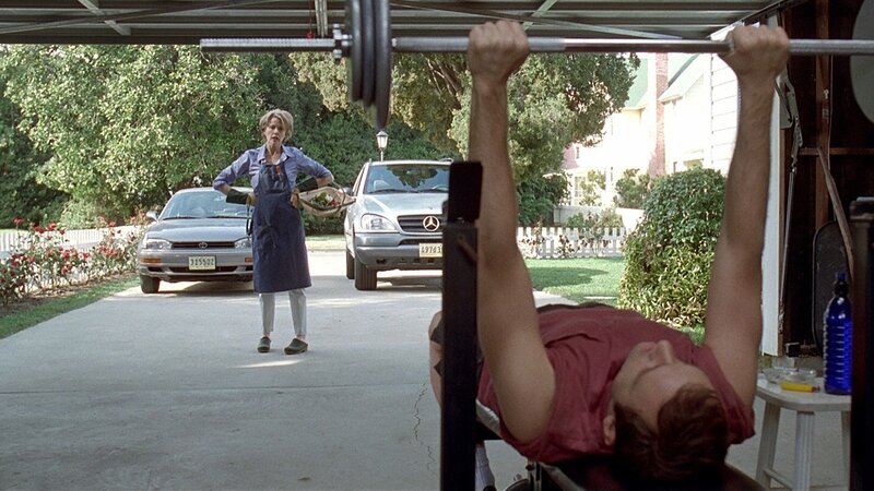 Man lifting weights in garage