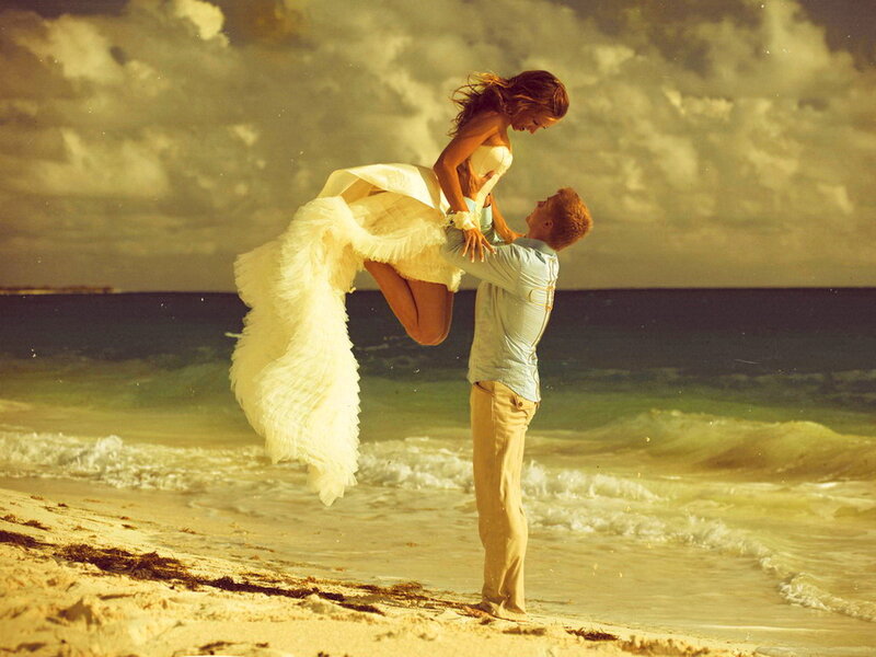 Man Lifting Woman on Beach
