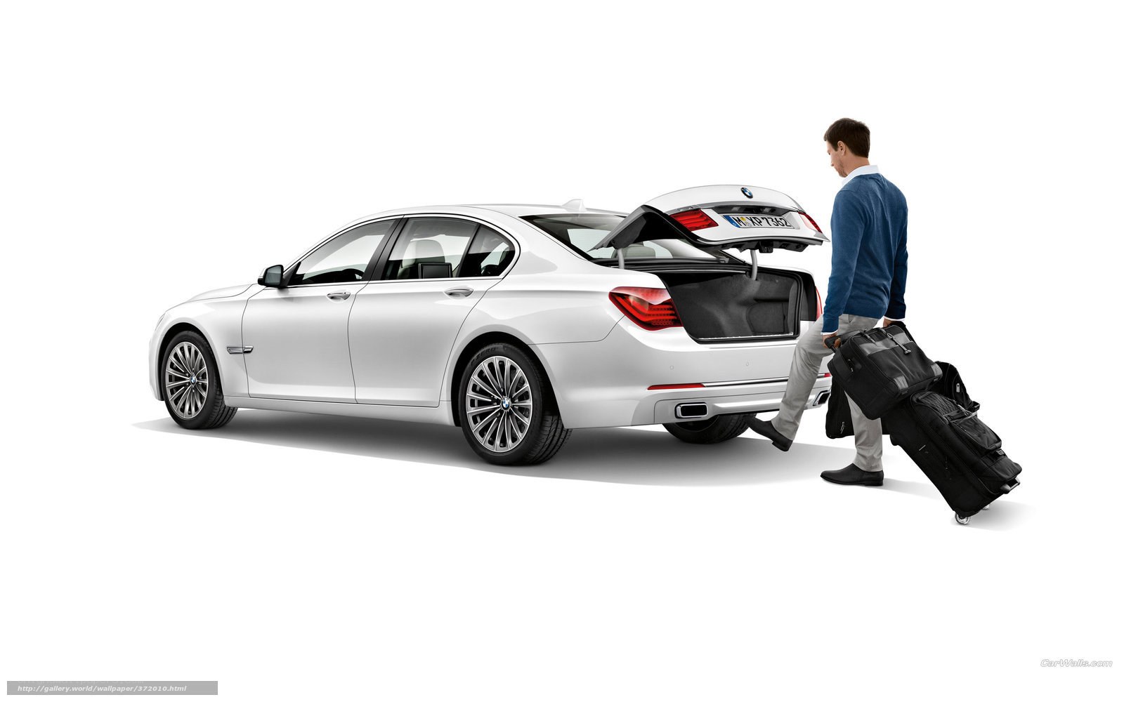 Man loading luggage into BMW