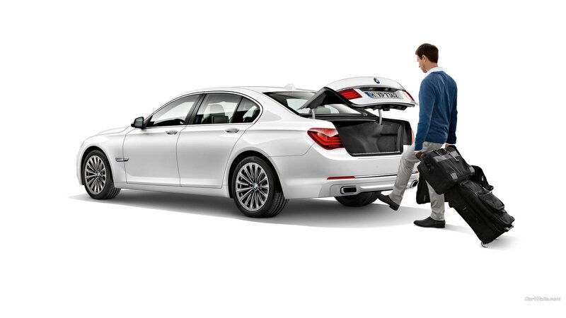 Man Loading Luggage into Car — White