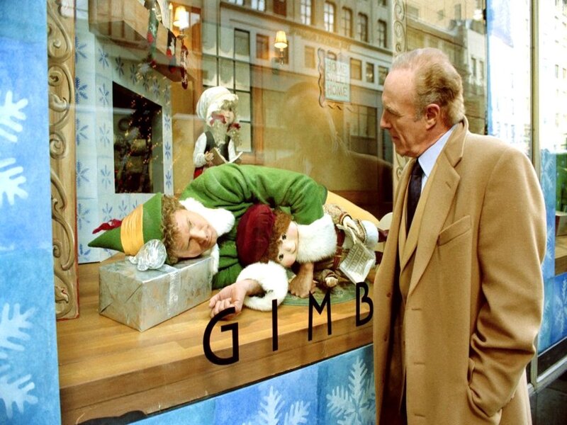 Man looking at elf in window display