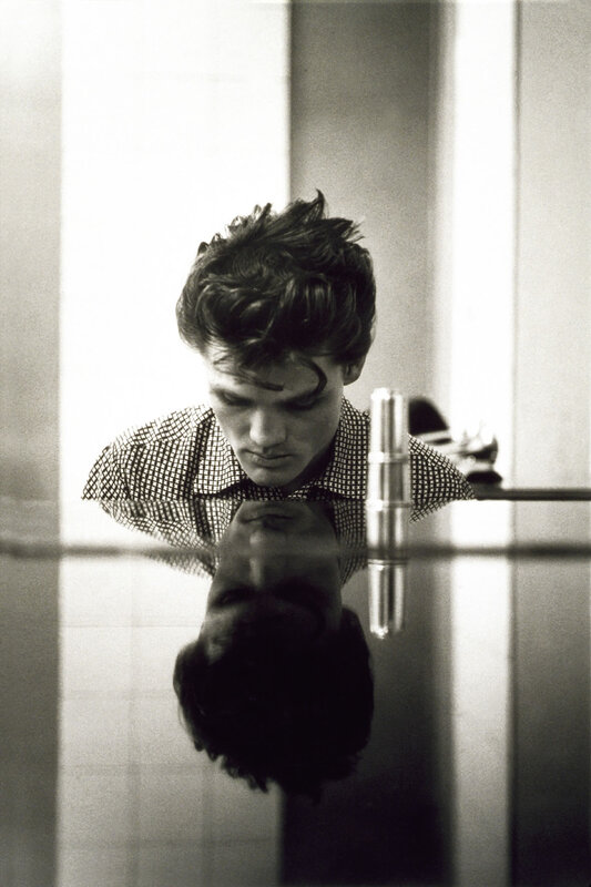 Man looking at his reflection