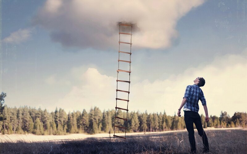 Man looking at ladder to cloud