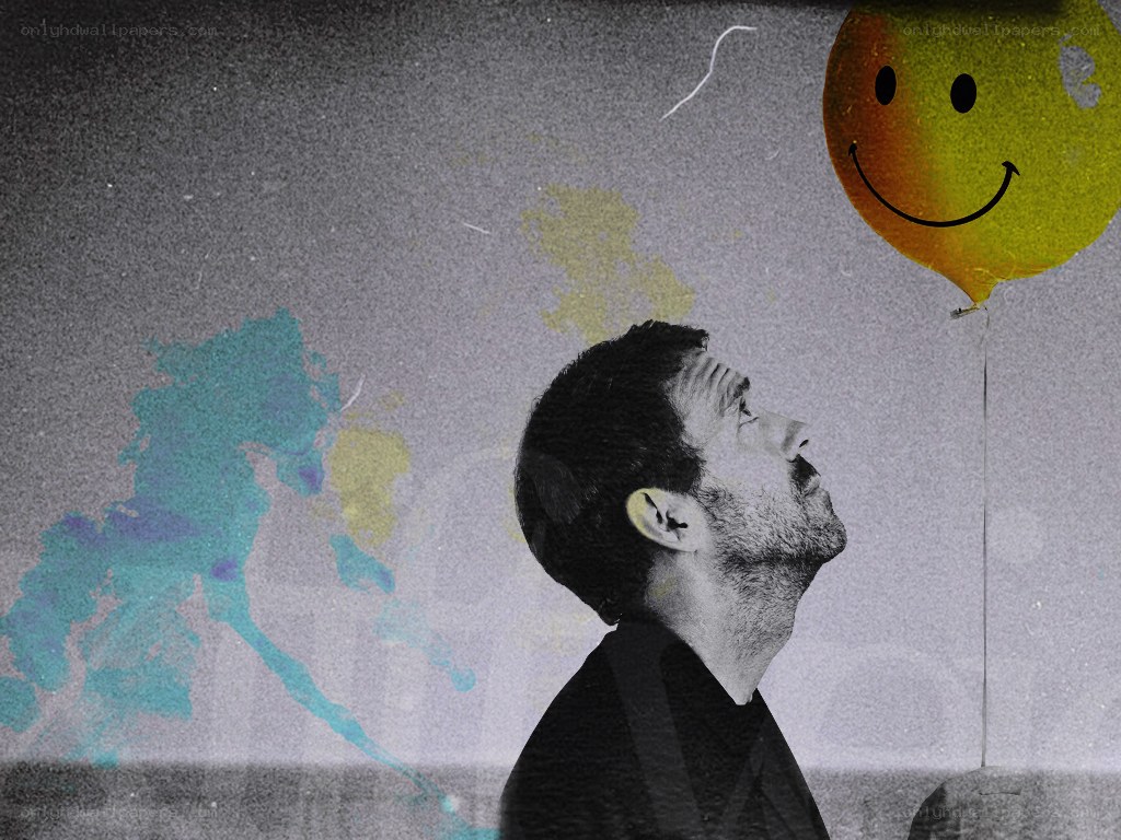 man looking at smiley balloon