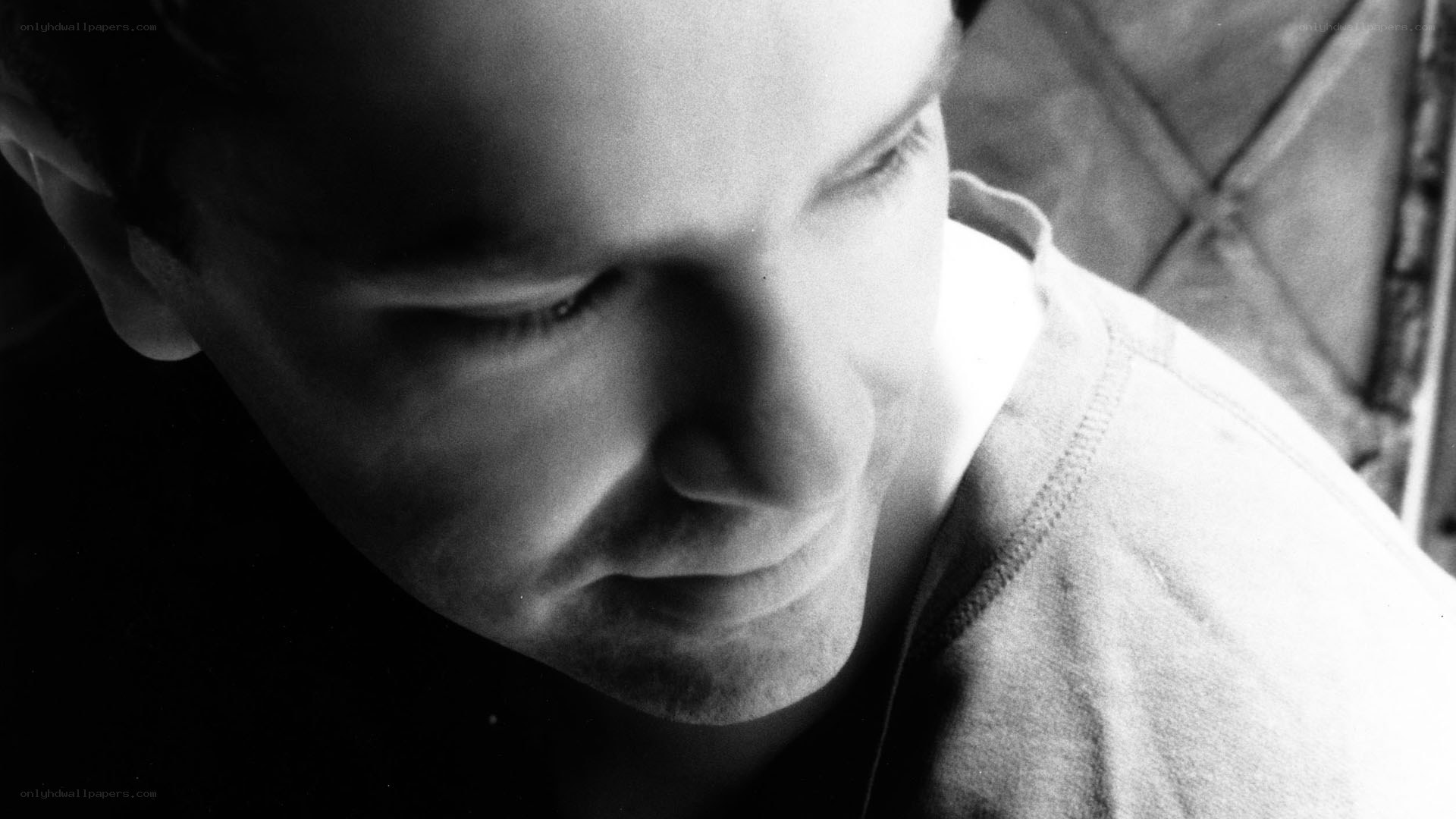 man looking down in black and white