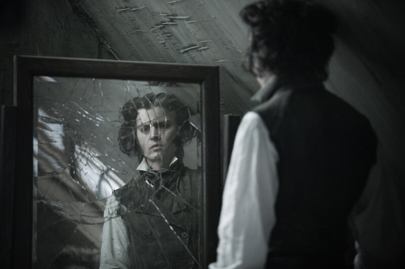 man looking in broken mirror