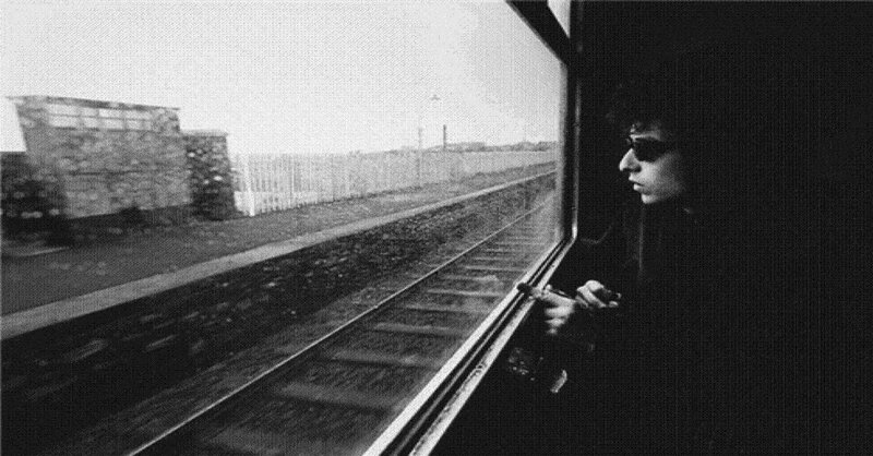 man looking out train window