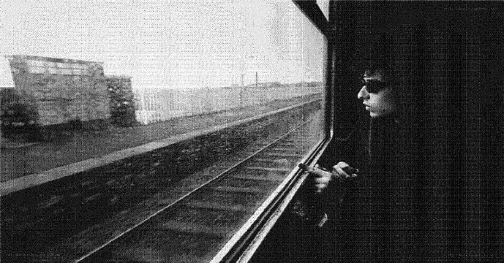 man looking out train window