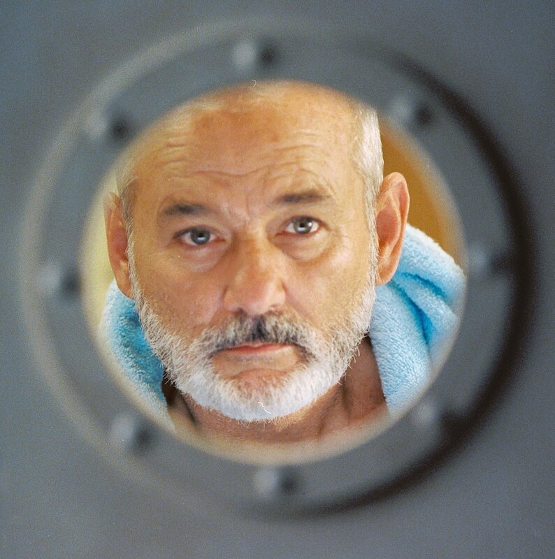 man looking through porthole