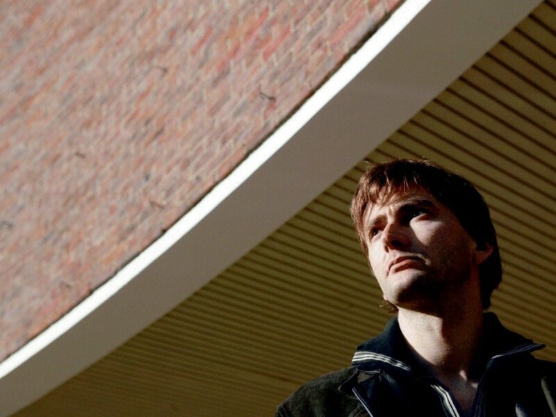 Man looking up at building
