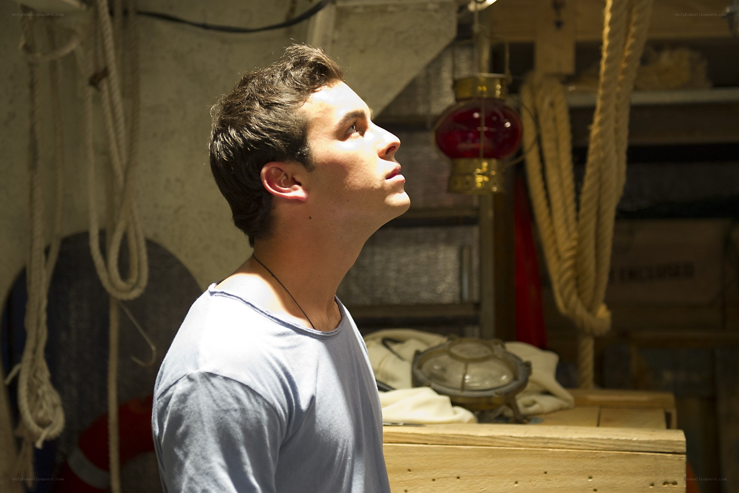 man looking up in ship hold