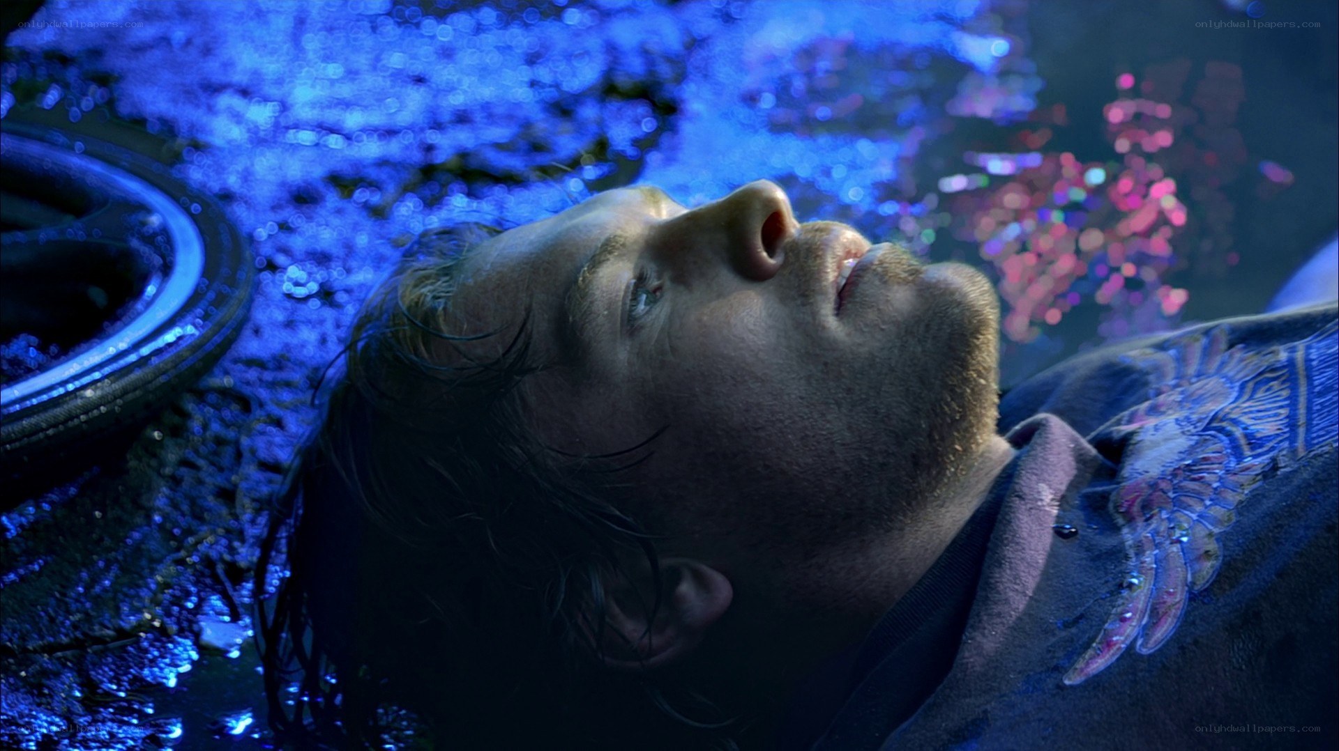 man lying in water at night